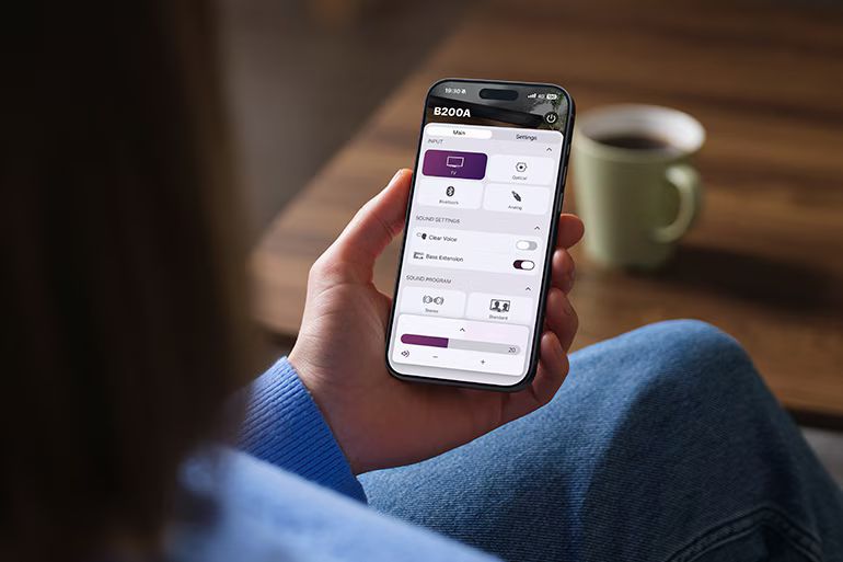 Person using the Sound Bar Remote app on a smartphone