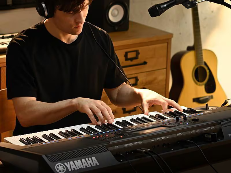 Photo of a person playing chords on the Yamaha Arranger Workstation PSR-SX720